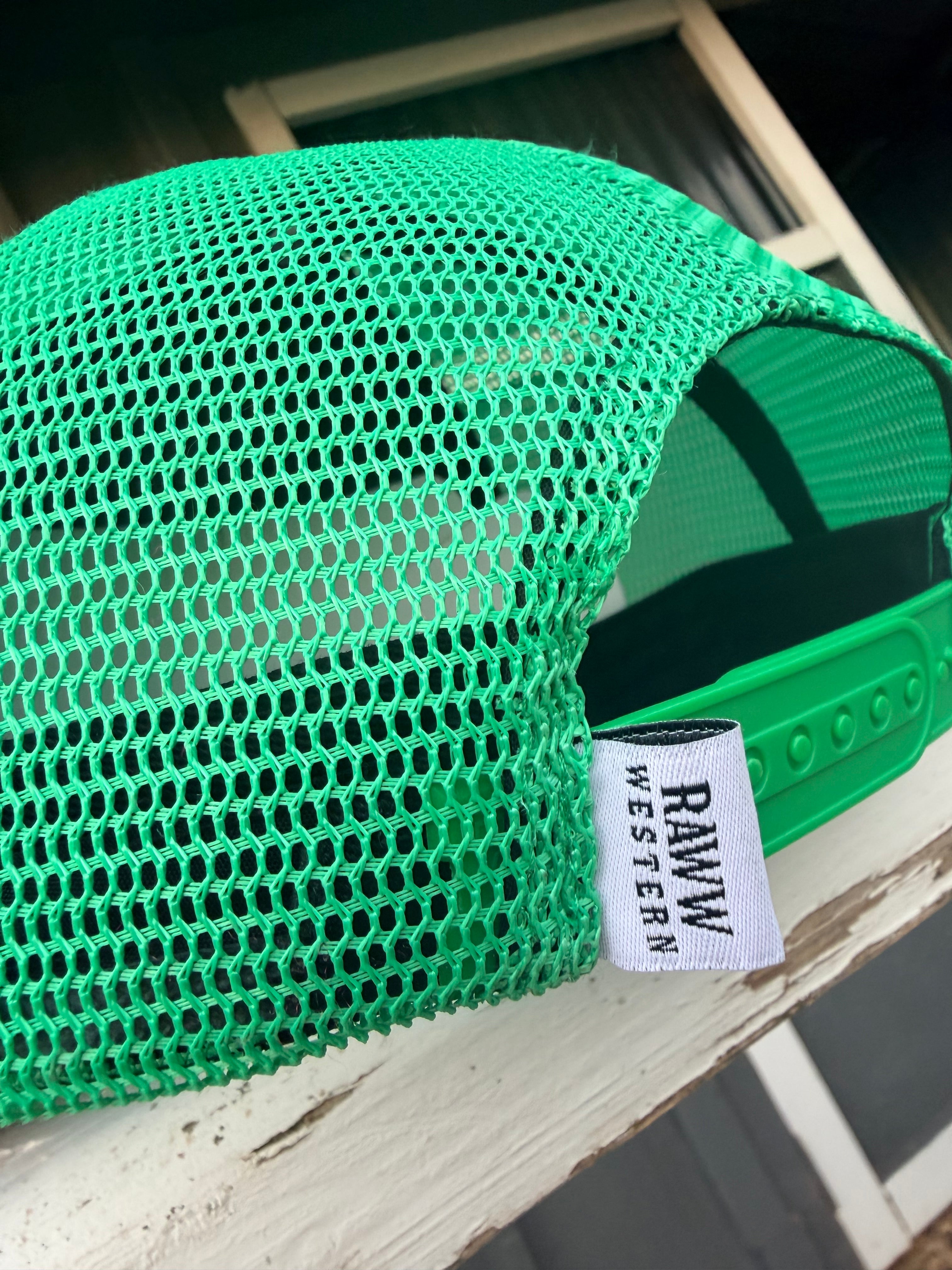 Green mesh back of ruby trucker cap with brand tag stitched inside