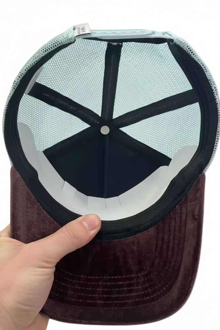 Trucker cap interior view with black crosshatch mesh and dark brown velvety back panel