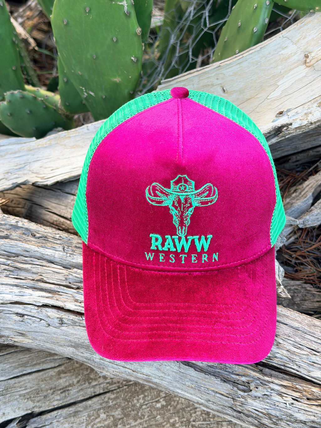 Ruby velvet trucker cap front view with green mesh back and RAW WES tern embroidered logo