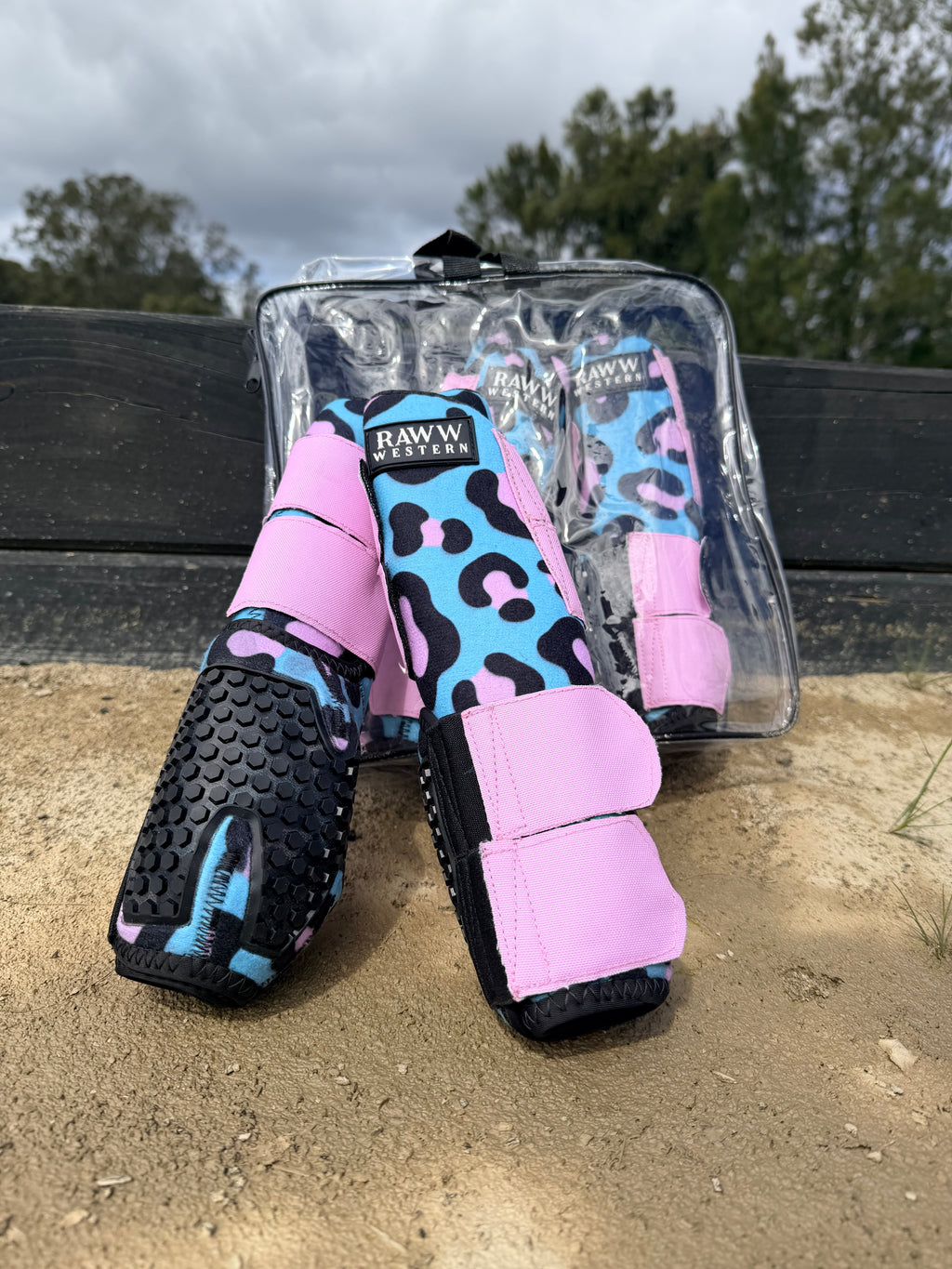 Leopard-print splint boots with pink and blue accents, black shell and hook strap detail