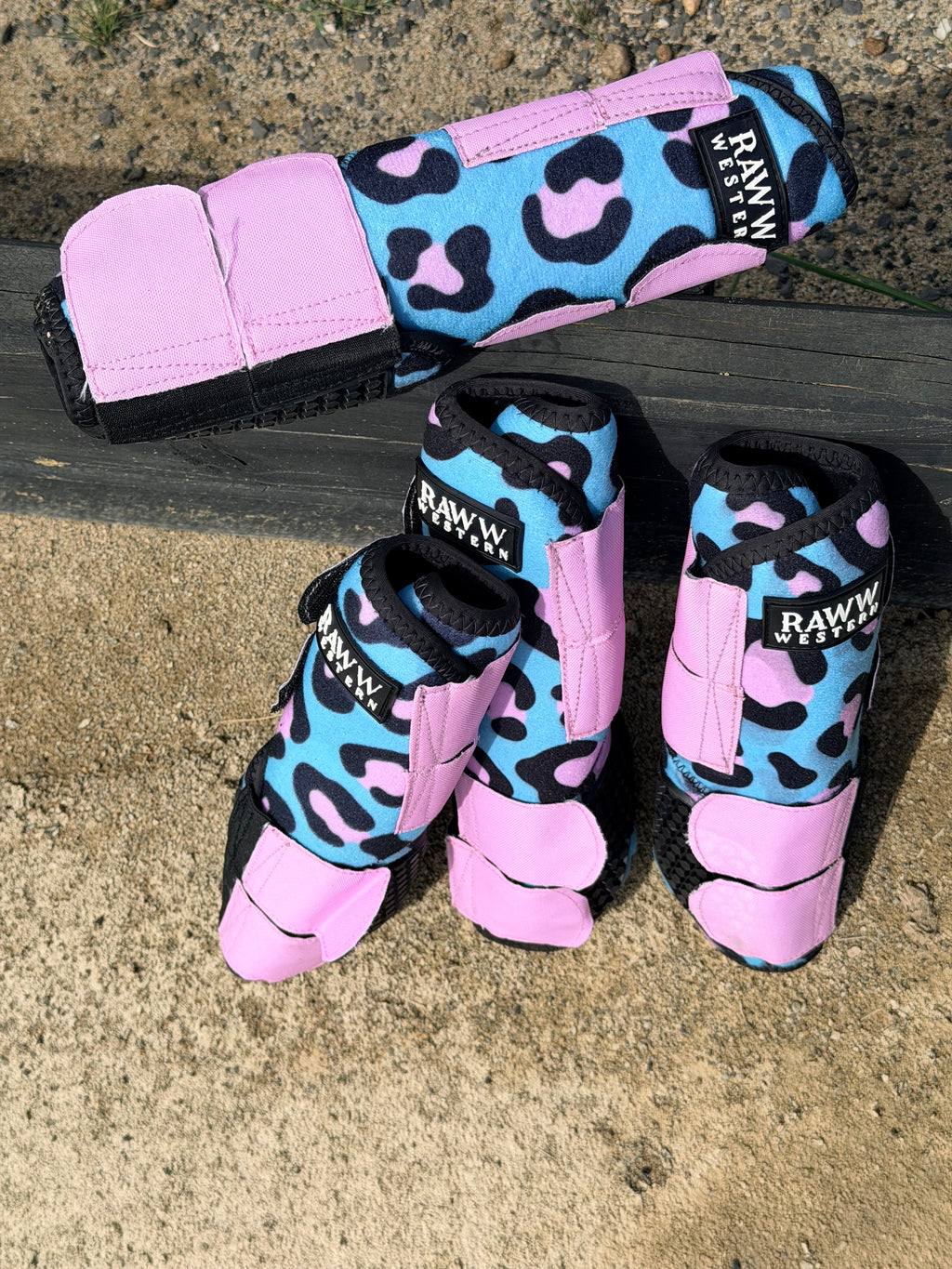 Leopard-print splint boots with pink cuffs and blue patterned panels, black toe guards