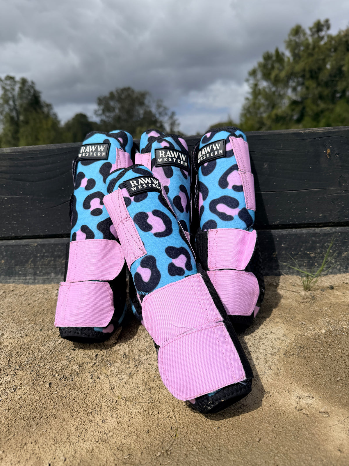 Pair of leopard-print splint boots in pink and blue with padded ankle straps