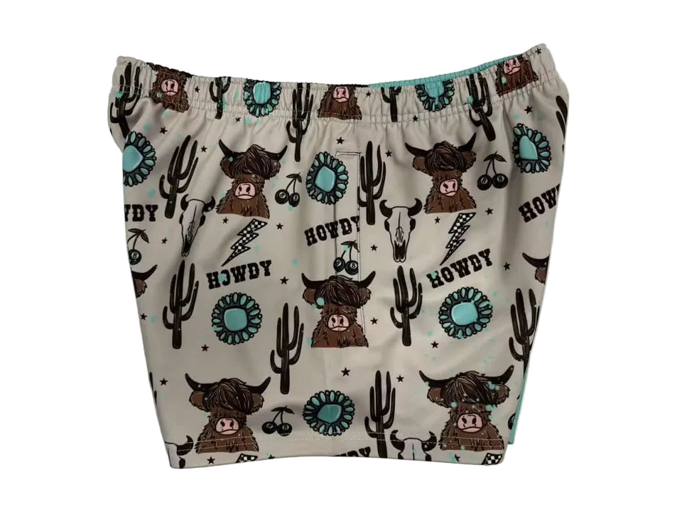 White footy shorts with cowboy-themed prints and elastic waistband