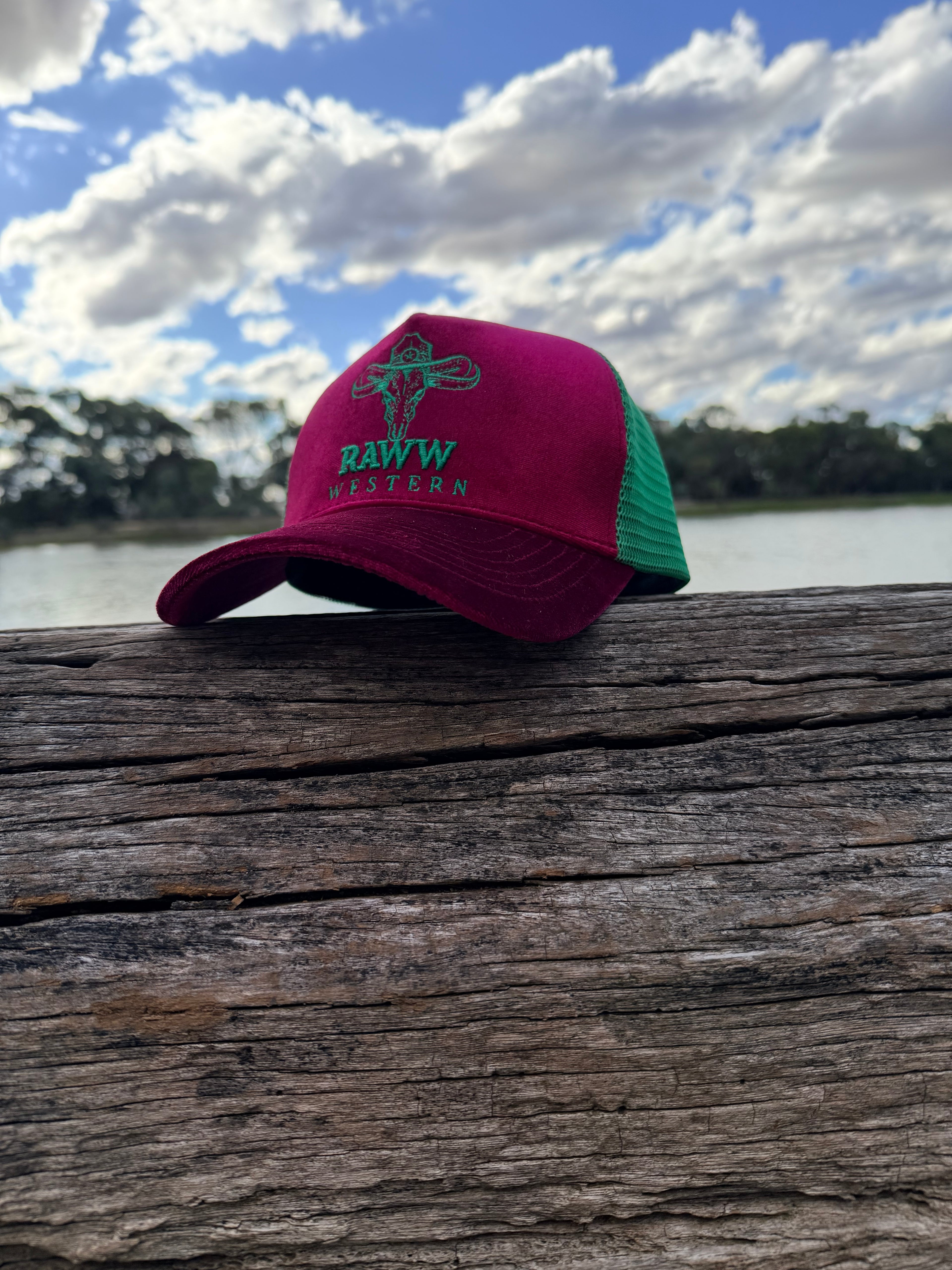 Ruby velvet trucker cap with green mesh back and embroidered RAW WES tern on front