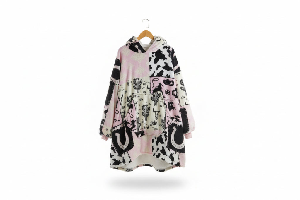 Cowgirl print hooded blanket poncho, pink and black shapes on light background