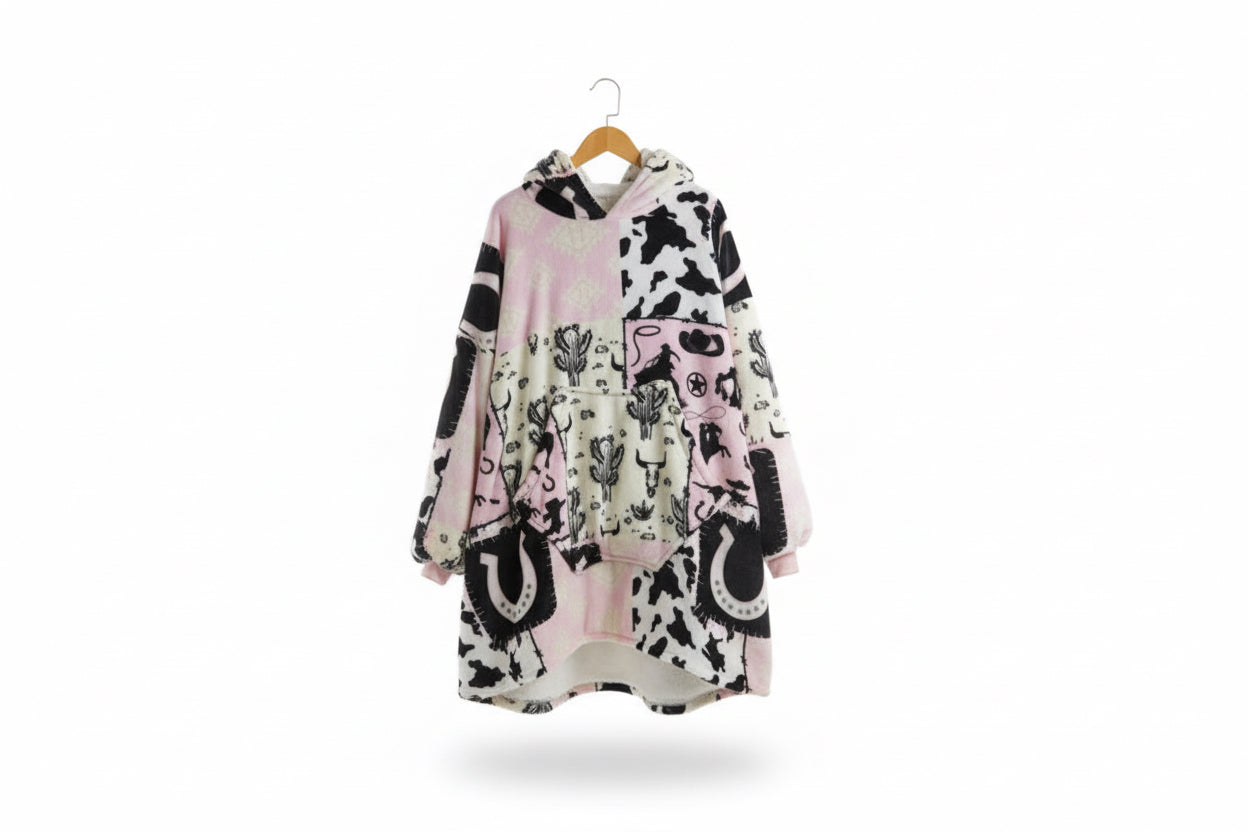 Cowgirl print hooded blanket poncho, pink and black shapes on light background